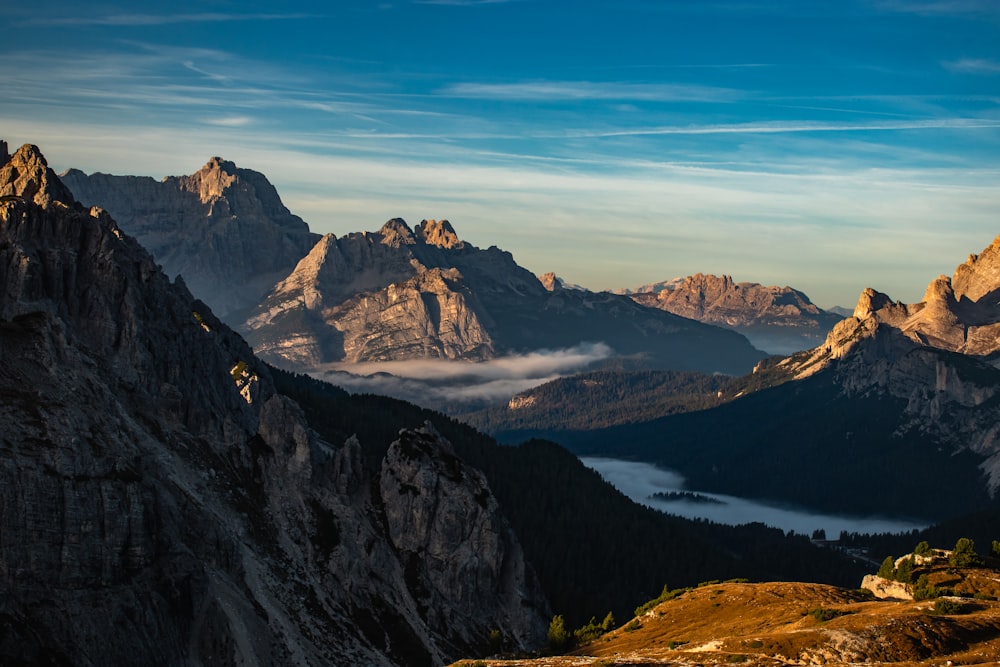 a view of a mountain range with clouds in the distance