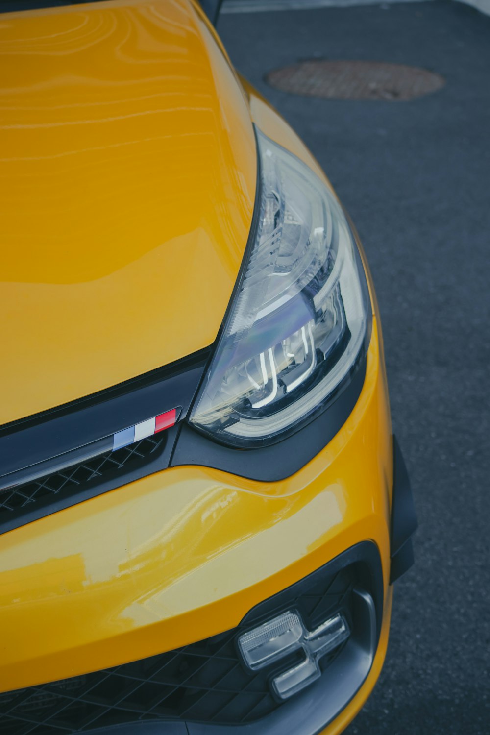 a close up of the front of a yellow car