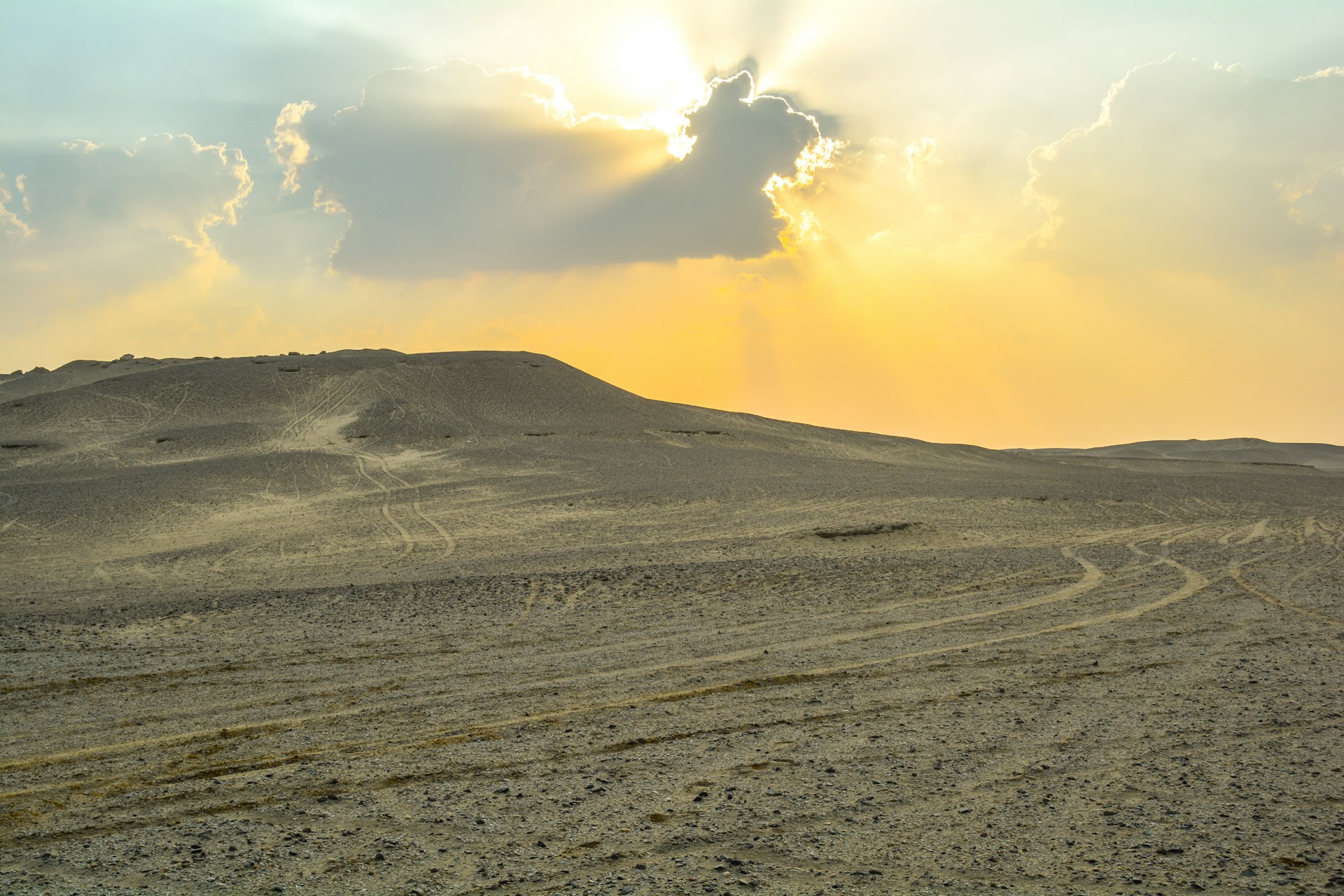 the sun is setting over the sand dunes