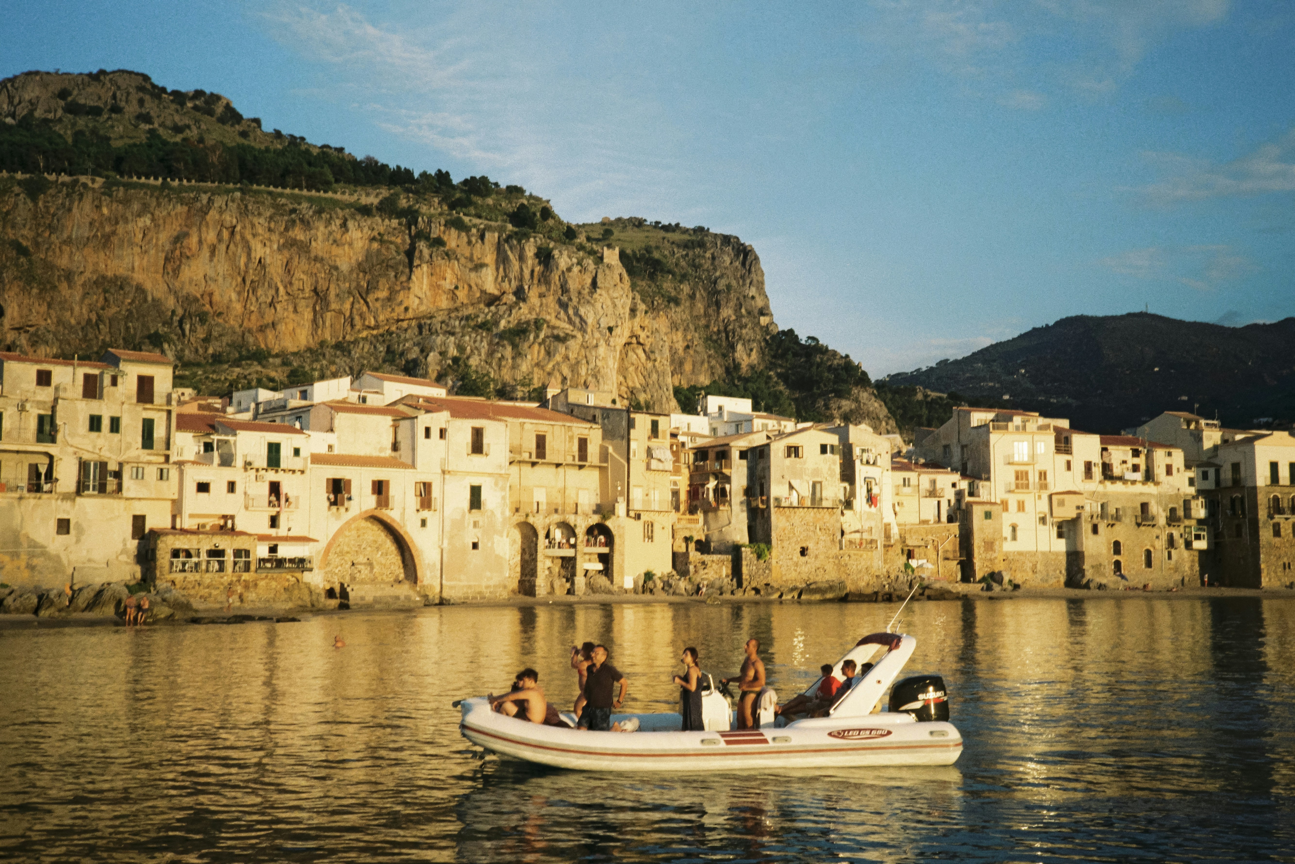 a group of people riding on the back of a boat