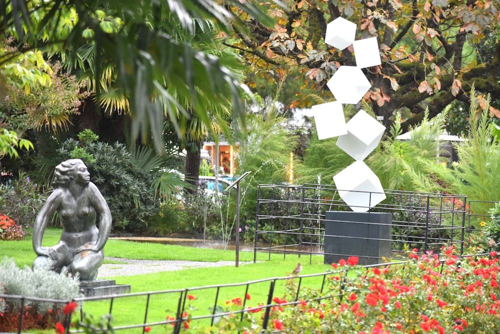 a statue of a woman in a garden