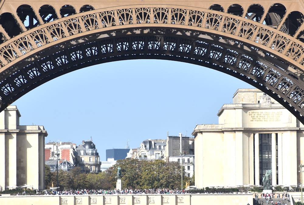 the view of the eiffel tower from under the bridge