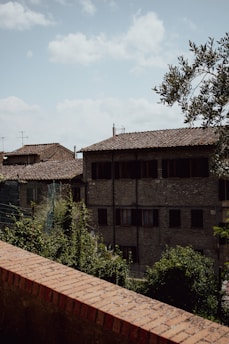 A peaceful street scene in Paperino village with traditional Tuscan houses under a clear blue sky.