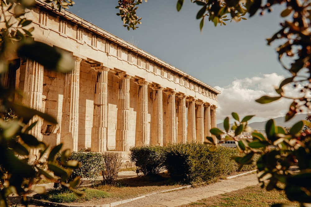 a large building with columns and a lot of trees