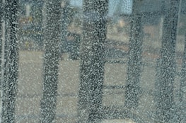Side-by-side view showing a shattered windscreen transformed into a flawless, clear glass.