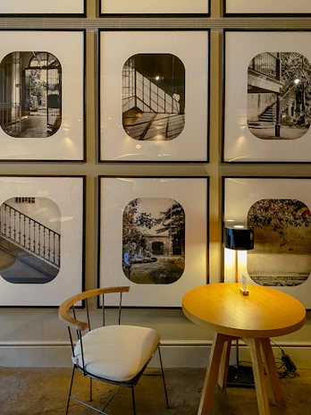 A chic black and white photographic print mounted in a sleek black frame displayed above a console table.