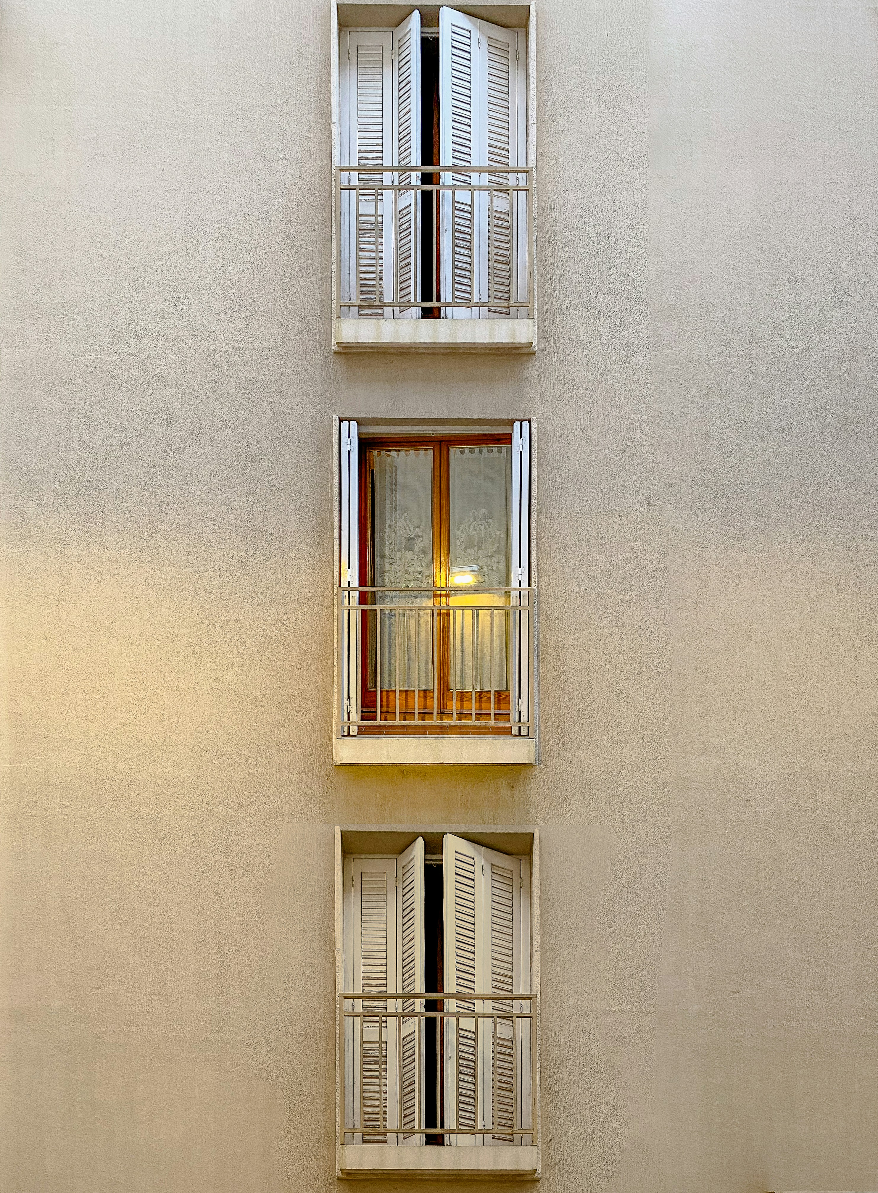 a tall building with two balconies and two windows