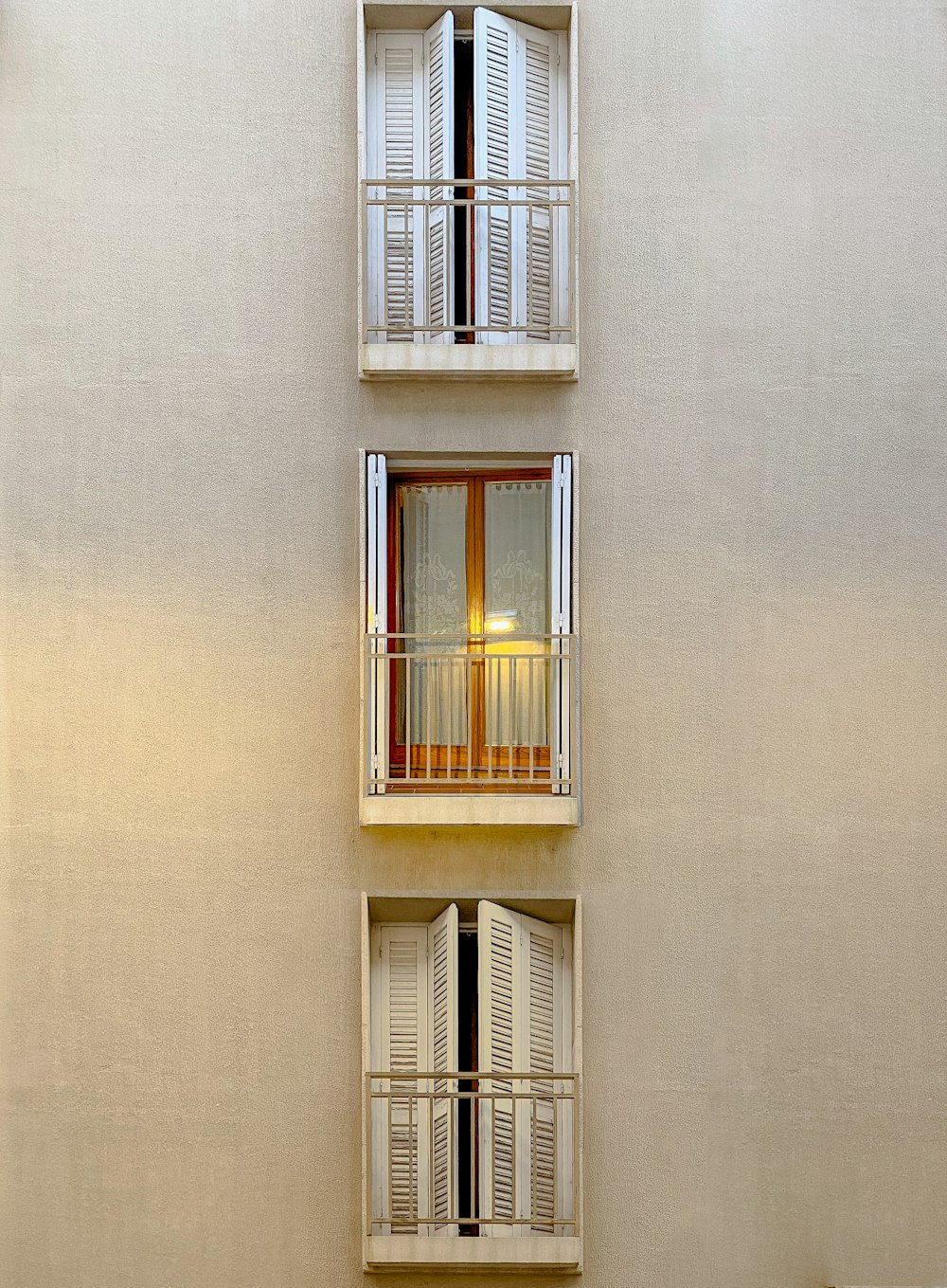 a tall building with two balconies and two windows