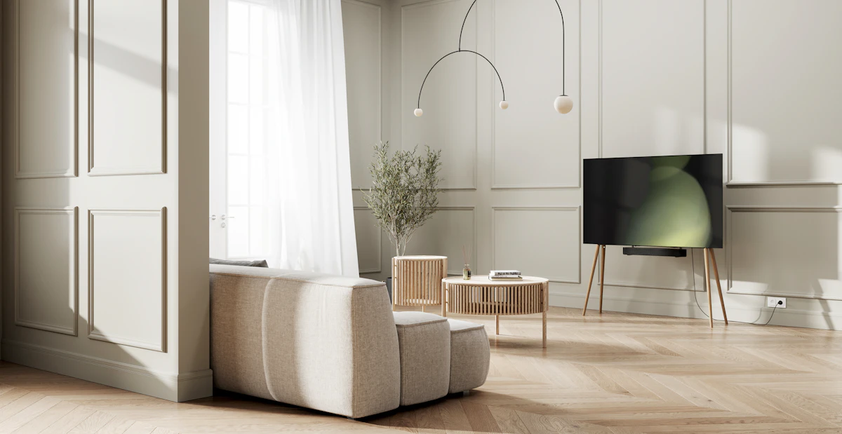 A large flat screen television mounted on the wall of a minimalist living room