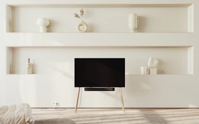 Modern plywood shelves installed in a bright, minimalist living room.