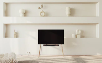 Floating shelves displaying books and decor in a cozy, minimalist living room.