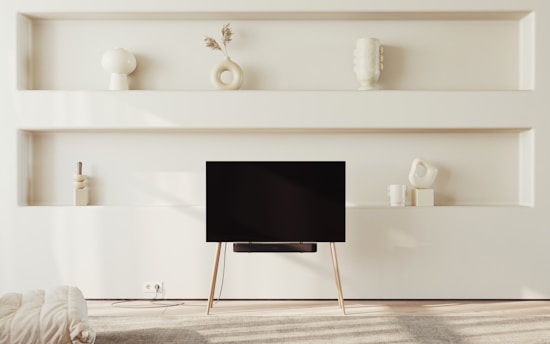 A peaceful, minimalist living room showing clean surfaces and organized shelves