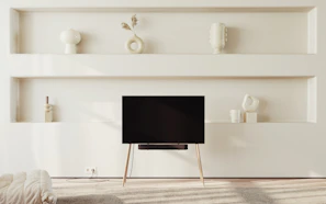 Elegant living room with bespoke wooden shelves and minimalist décor.