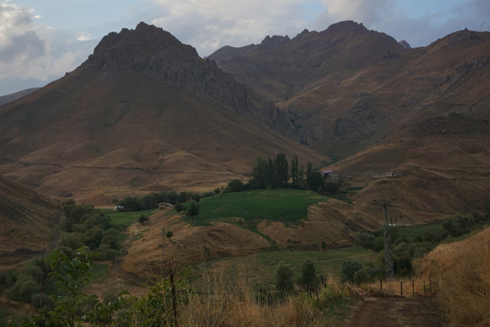 a view of a mountain range with a house in the foreground