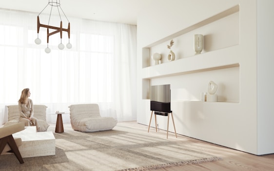 A sleek, minimalist living room featuring neutral tones with bold color accents and spacious, airy design.