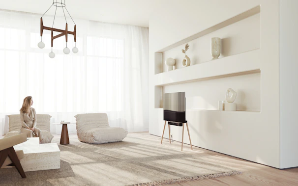 A serene living room featuring soft gold-accented lighting and minimalist furniture in neutral tones.