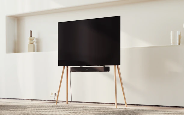 Contemporary smart TV mounted on a minimalist wall with ambient lighting.