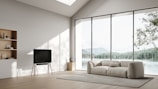 Interior view of a spacious, well-lit living room with minimalist decor.