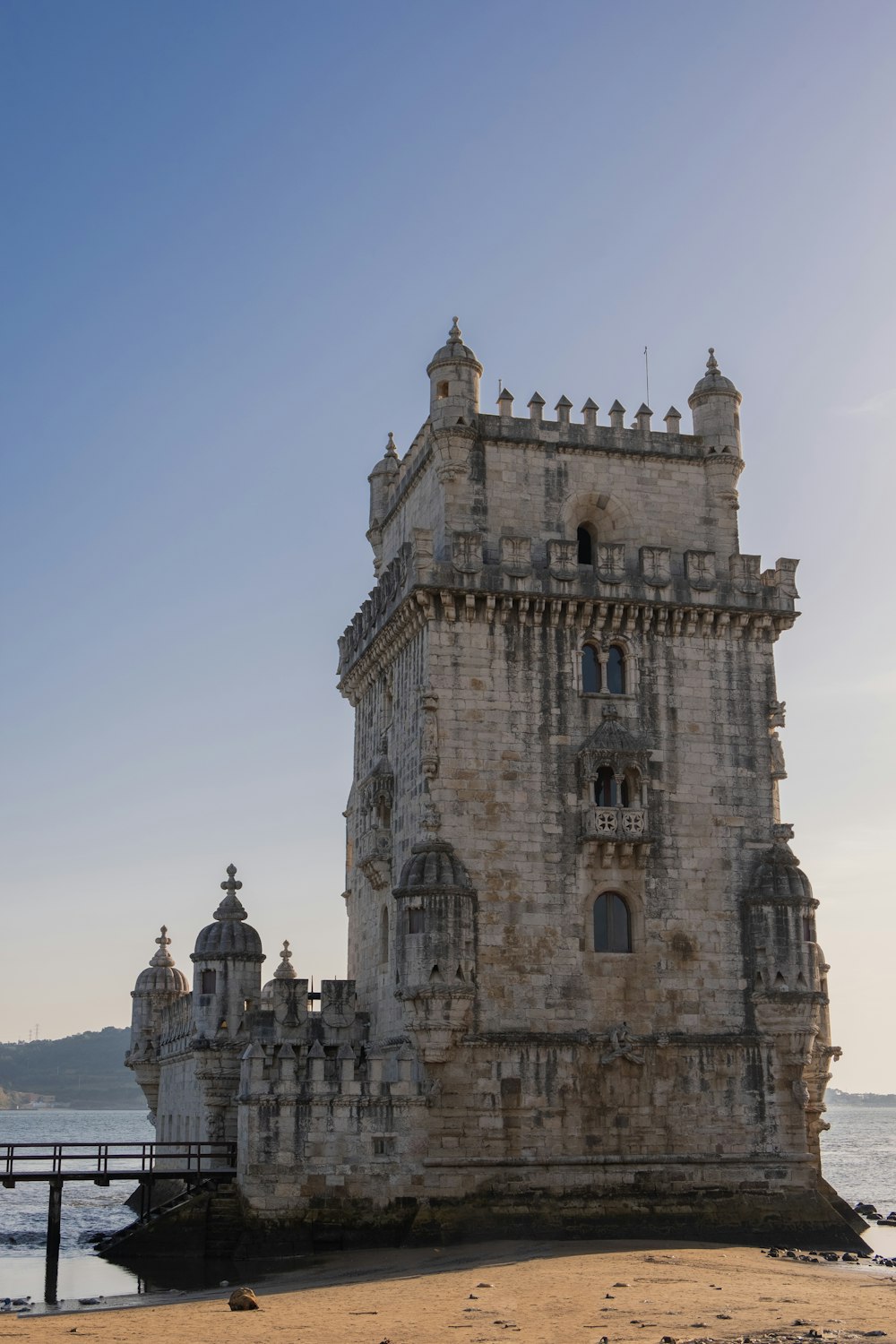 a large tower sitting on top of a sandy beach