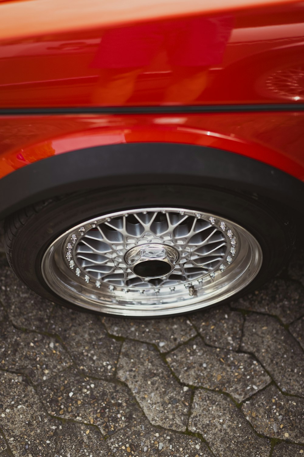 a close up of a tire on a red car