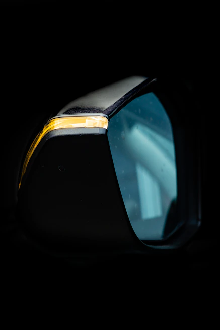 Side mirror for a long-distance bus mounted on a vehicle, showcasing sleek design