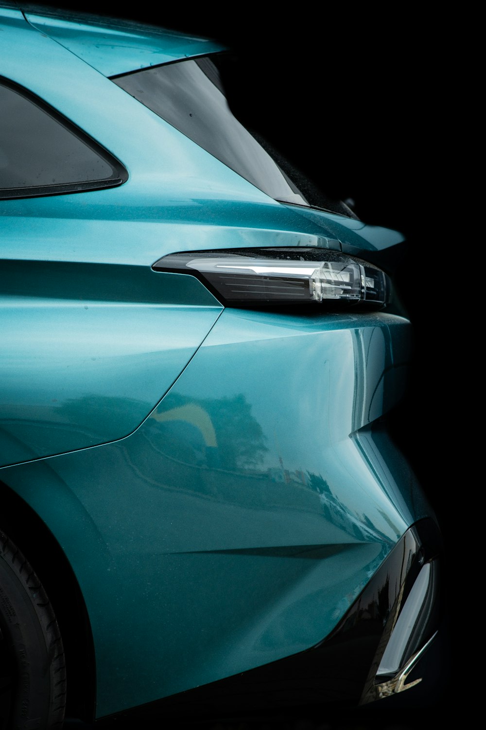 a close up of a blue car with a black background