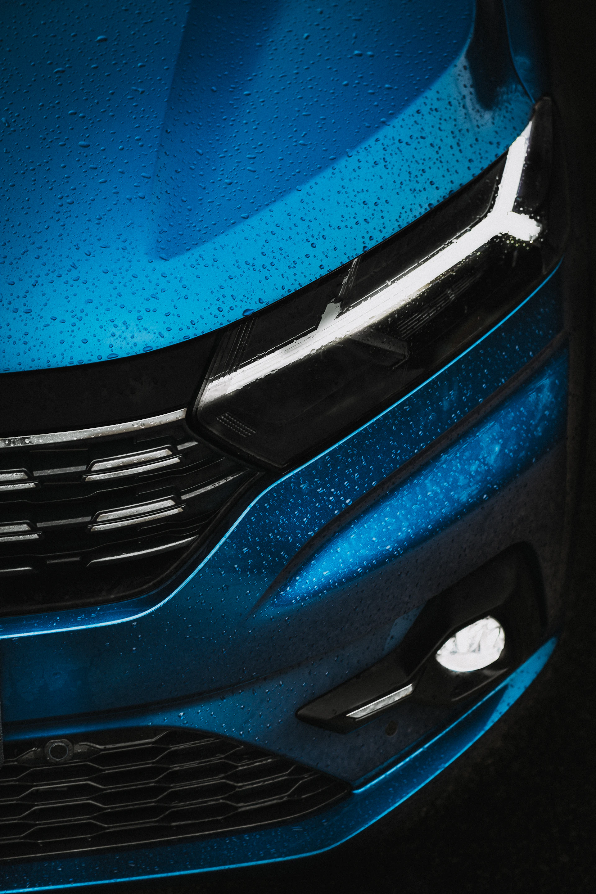 a close up of the front of a blue car