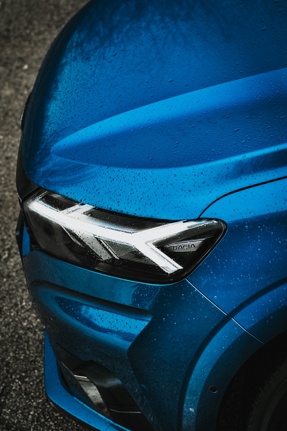 a close up of the front of a blue car