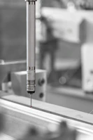 Quality control specialist inspecting coated surfaces using advanced measurement tools