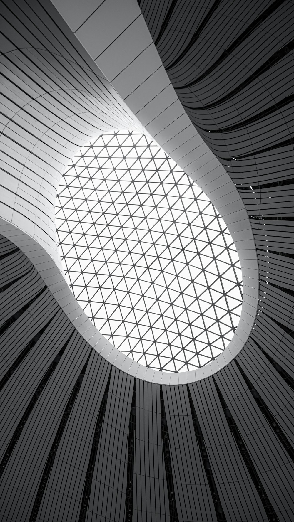 the ceiling of a building with a large glass window