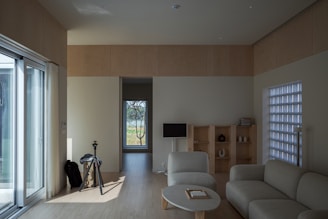 a living room filled with furniture and a sliding glass door