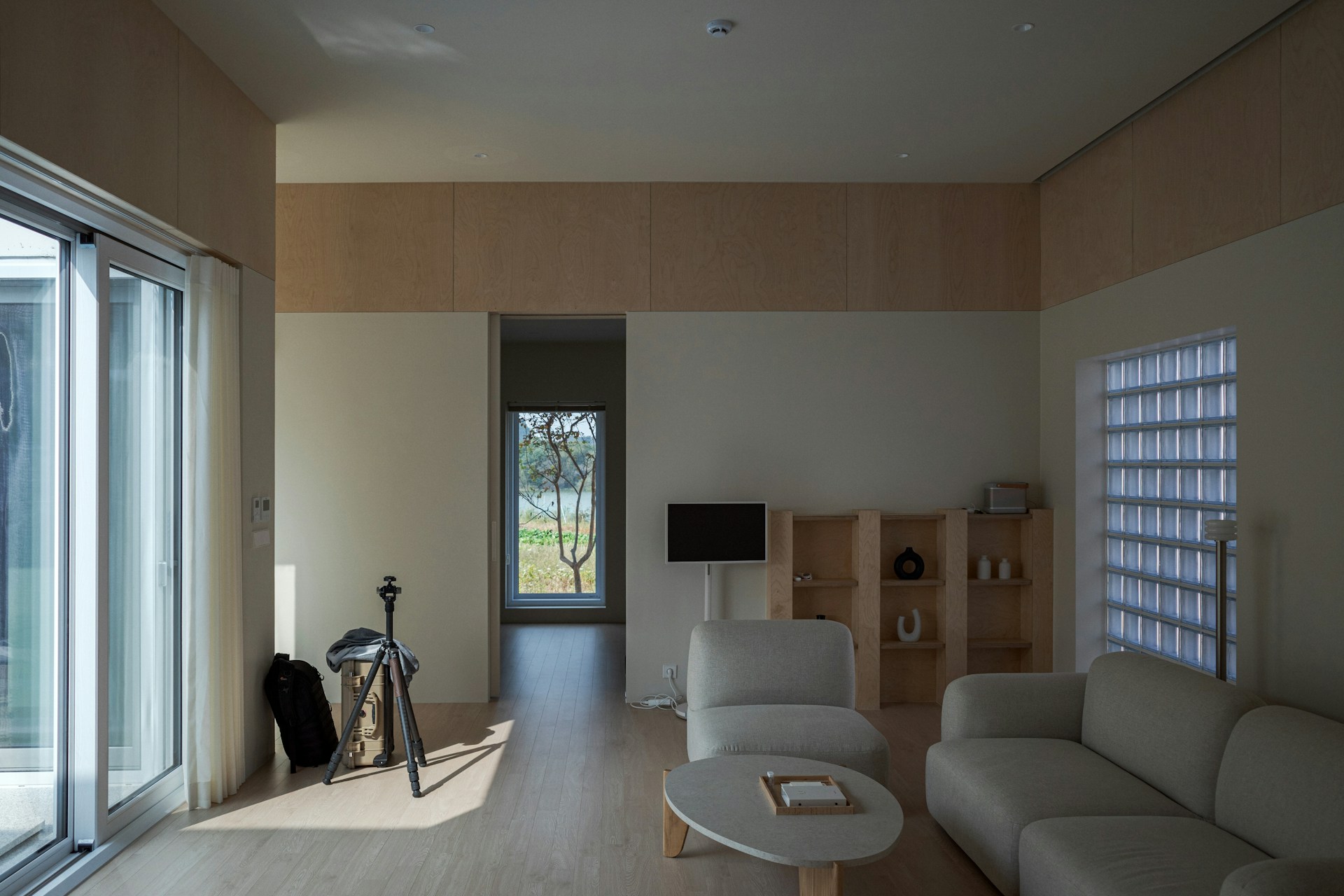 a living room filled with furniture and a sliding glass door