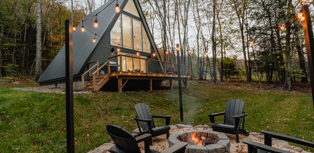 a small cabin with a fire pit in the yard