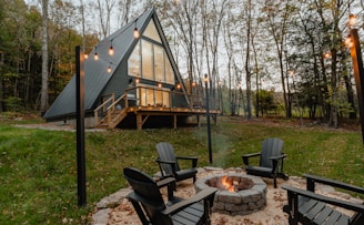 a small cabin with a fire pit in the yard