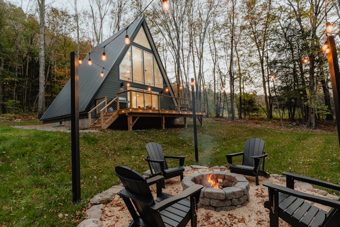a small cabin with a fire pit in the yard