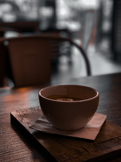 Cozy coffee cups arranged on a wooden table in warm lighting.