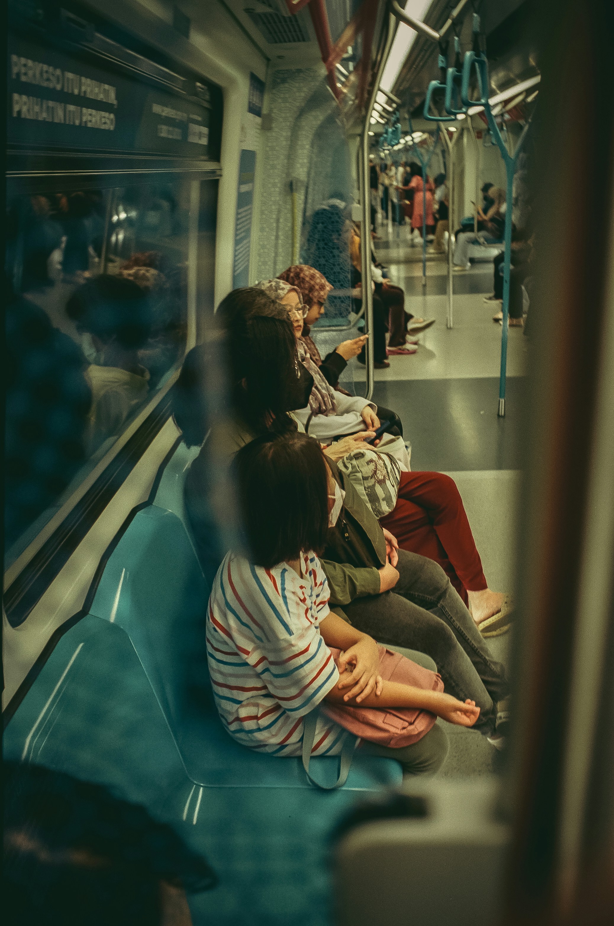 a group of people sitting on a train next to each other