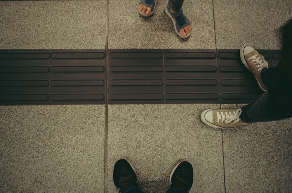 a couple of people standing on top of a floor