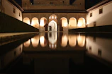 Evening view of the hotel’s courtyard with soft lighting creating a tranquil atmosphere.