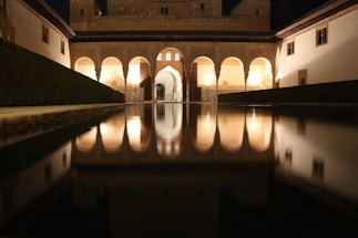 A warm Moroccan riad courtyard with inviting seating and soft lantern light at dusk.