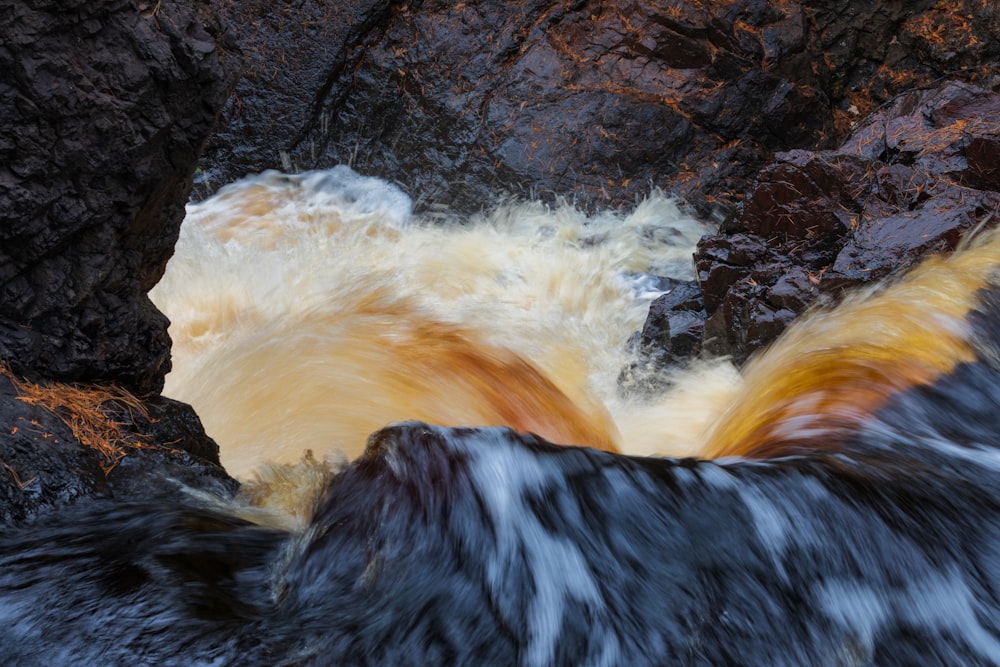 the water is rushing over the rocks in the river