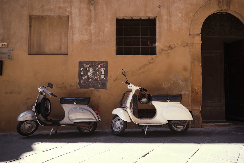 a couple of scooters parked next to a building