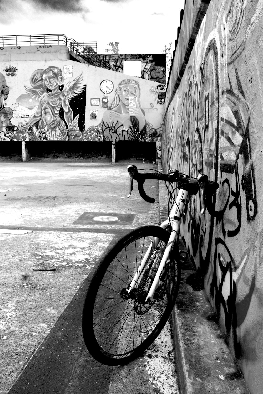 a bike leaning against a wall with graffiti on it