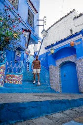 Iconic blue-painted streets and staircases of Chefchaouen adorned with flower pots and vibrant walls.
