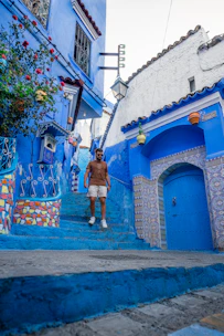 Iconic blue-painted streets and staircases of Chefchaouen adorned with flower pots and vibrant walls.