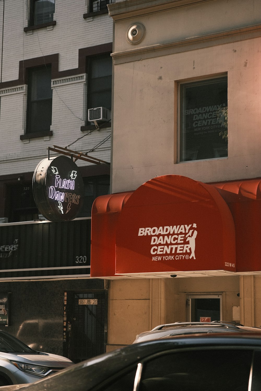 a sign for broadway's dance center in front of a building