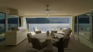 A charming lakeside home with a modern design and large windows overlooking the water.