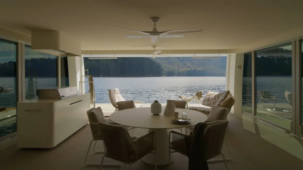 Bright and airy living room with modern furnishings and large windows overlooking Lake Oswego.