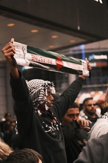 a group of people holding up signs in the air