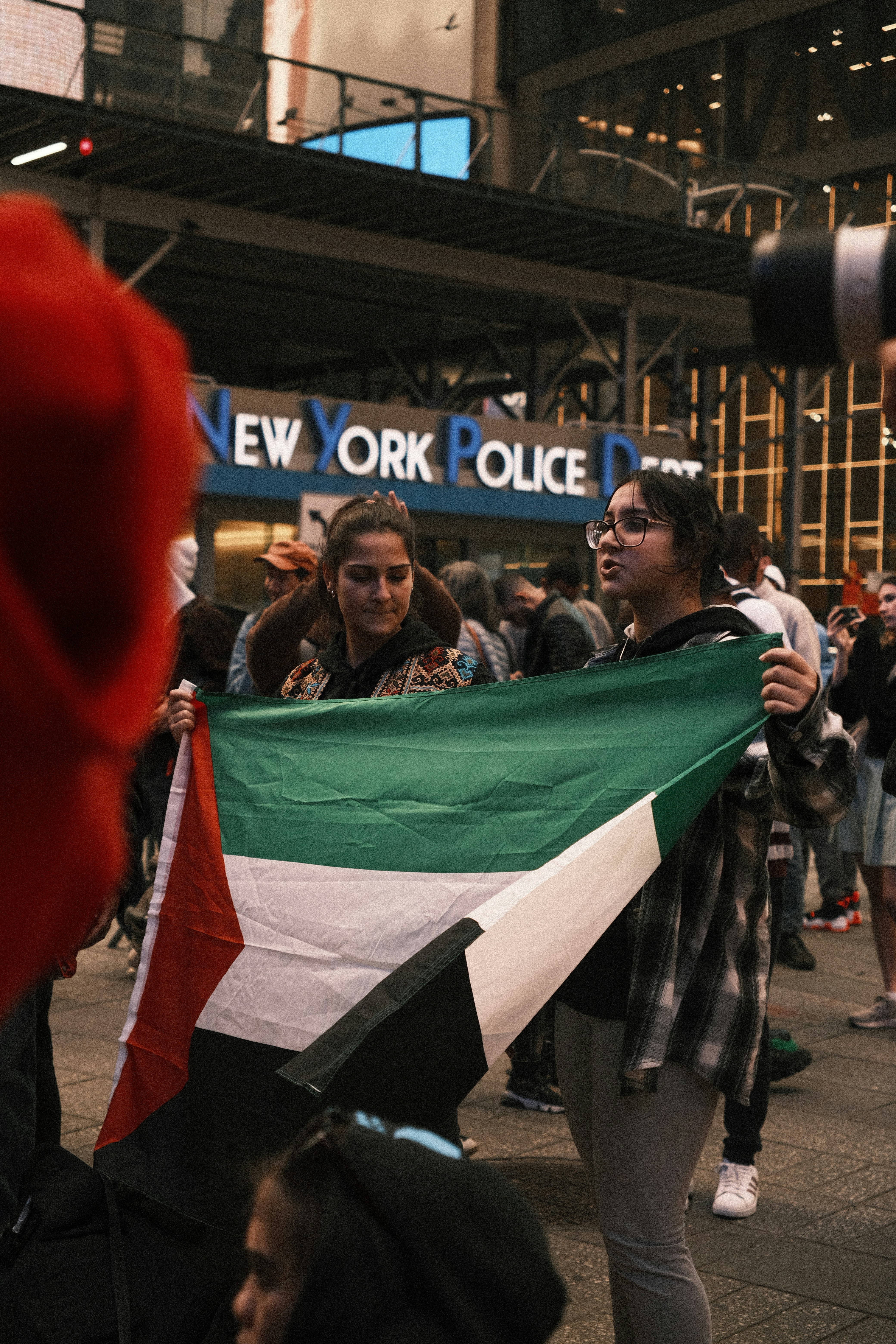a group of people walking down a street holding a flag